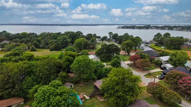 an aerial view of a house with garden space and street view