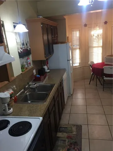 a room with furniture a rug and kitchen view