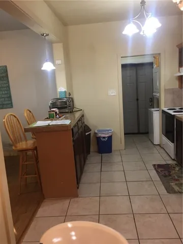 a view of a room with two chairs and a window