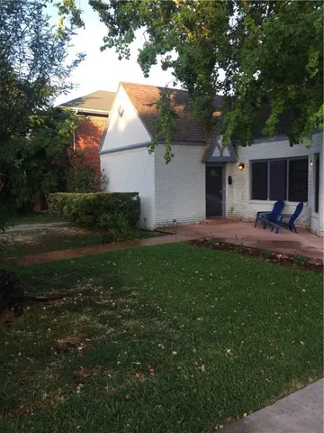 a house view with a sitting space and garden
