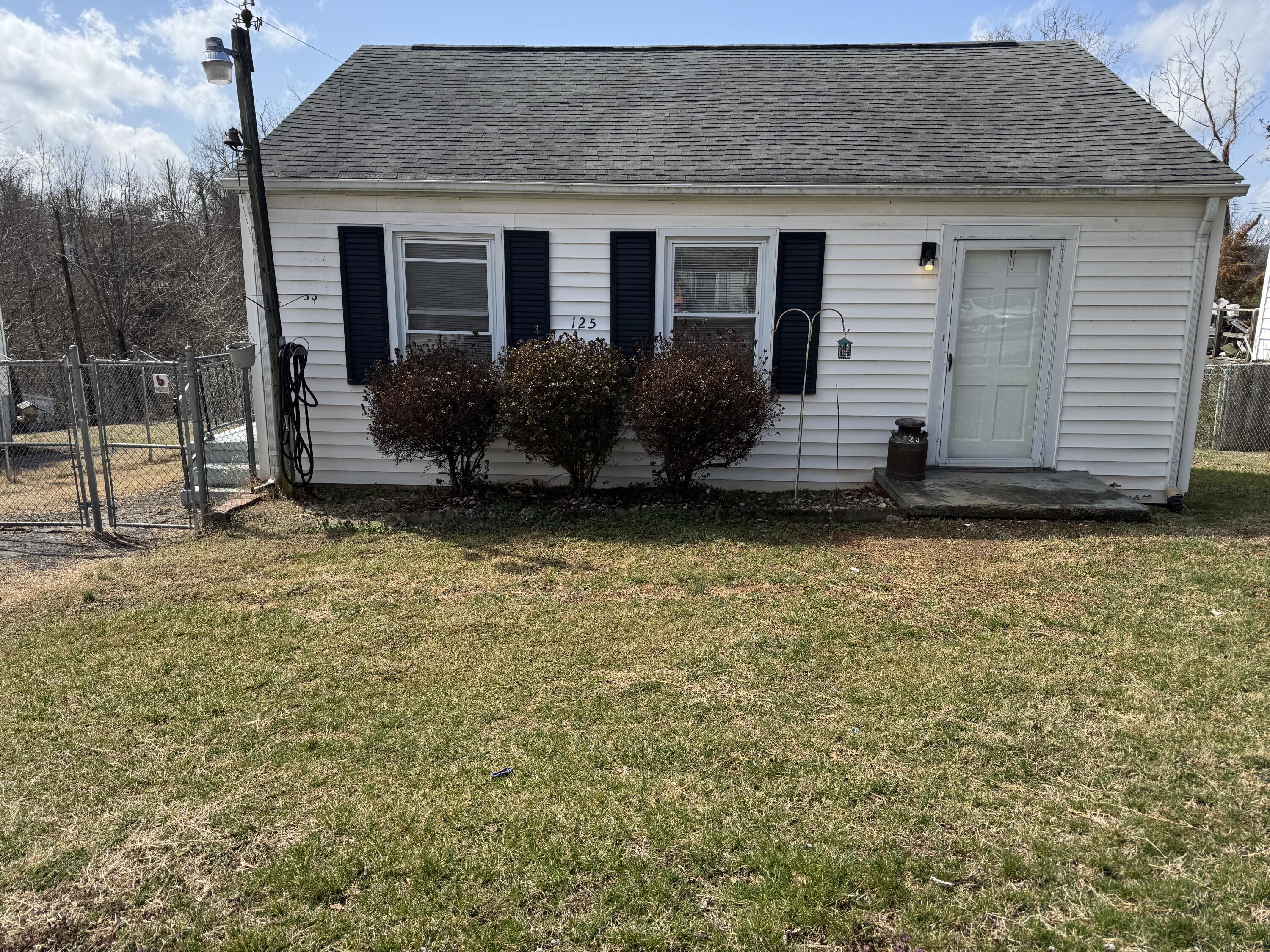 a view of front of house with a yard
