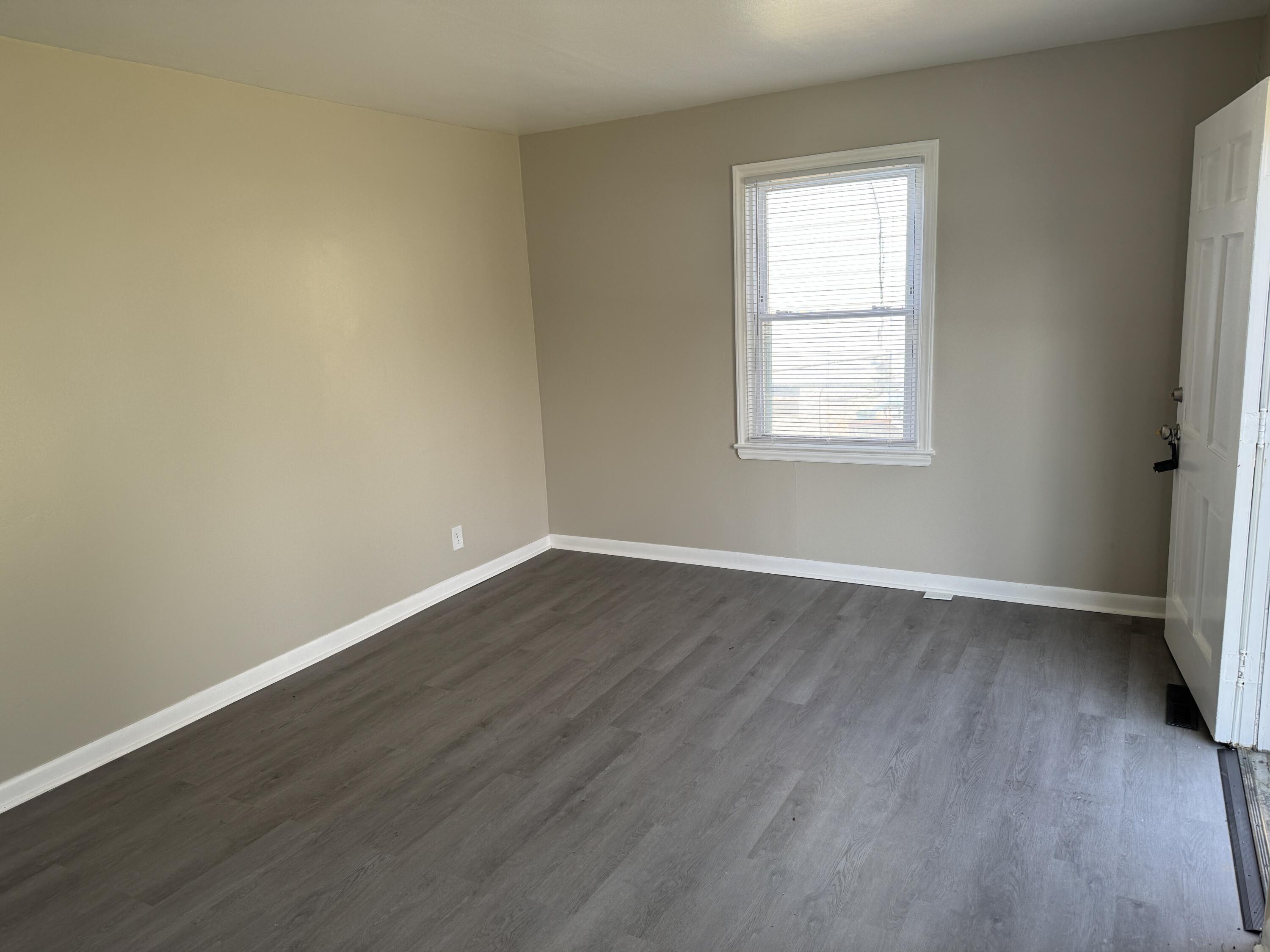 125 Elam Drive Ridgeway, VA 24148 - Photo 3 of 10 a view of an empty room with wooden floor and a window