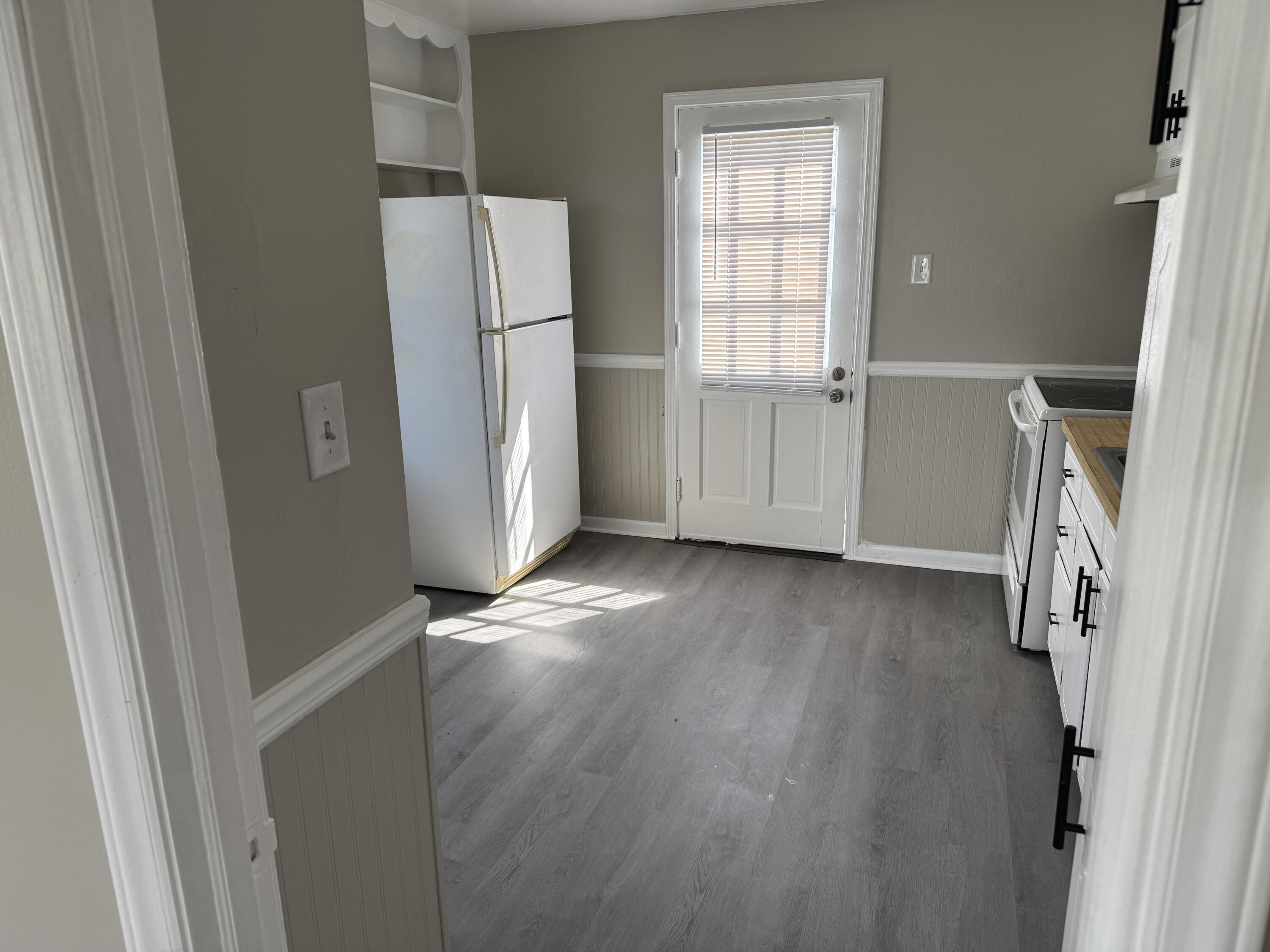 125 Elam Drive Ridgeway, VA 24148 - Photo 8 of 10 an empty room with wooden floor and a window