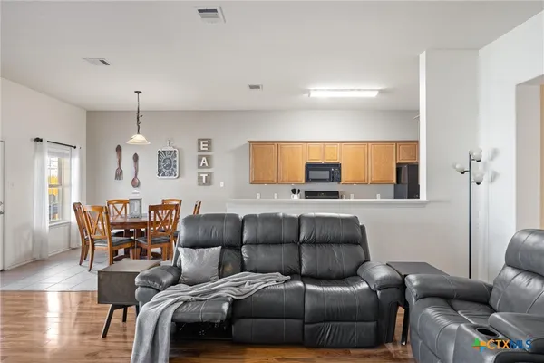 a living room with furniture and wooden floor