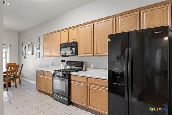 a kitchen with stainless steel appliances a refrigerator stove and microwave