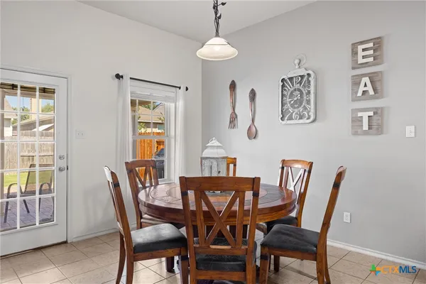 a dining room with furniture and window