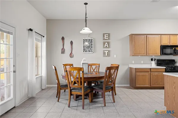 a dining room with furniture and window