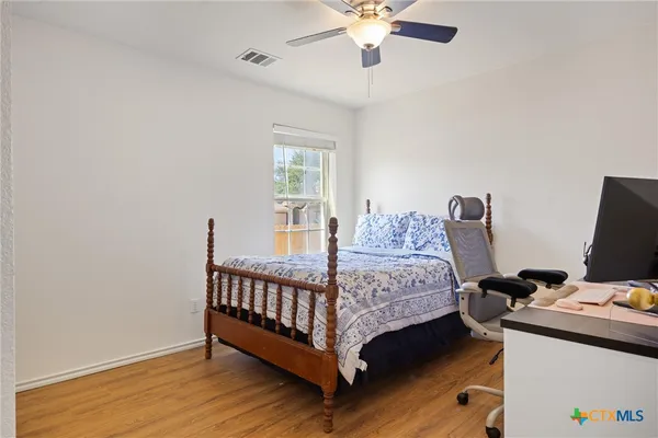 a bedroom with a bed and a chandelier