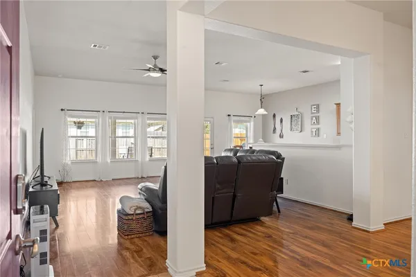 a living room with furniture and wooden floor