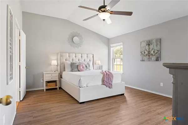 a bed sitting in a bedroom next to a window