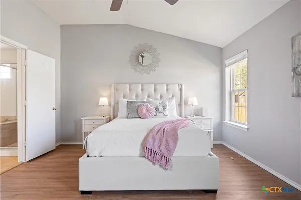 a bedroom with a large bed and a window