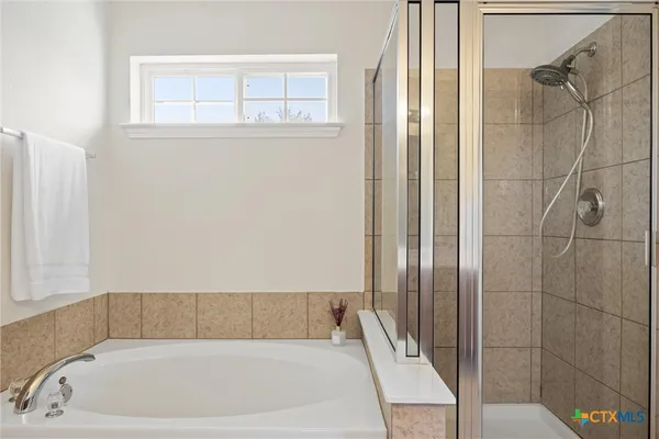 a bathroom with a tub and shower