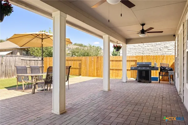 a view of a hallway with a dining table and a chandelier