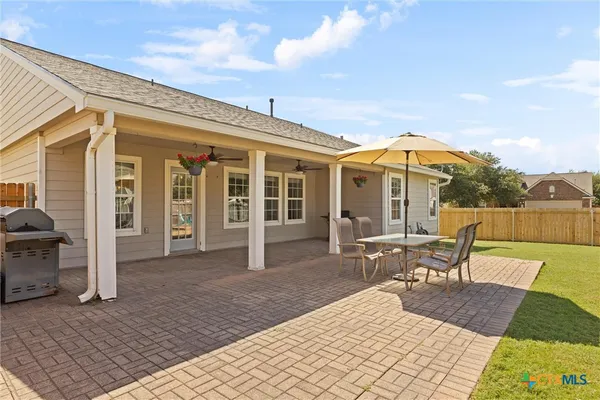 a view of a house with swimming pool and sitting area