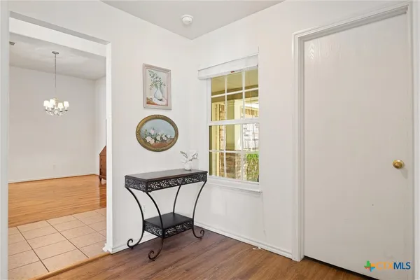 a view of a workspace with wooden floor and a window