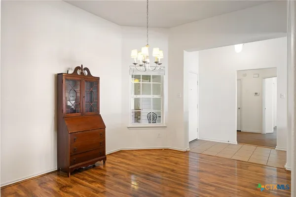 a view of a livingroom with wooden floor and a window