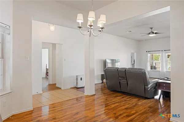 a living room with furniture and a chandelier
