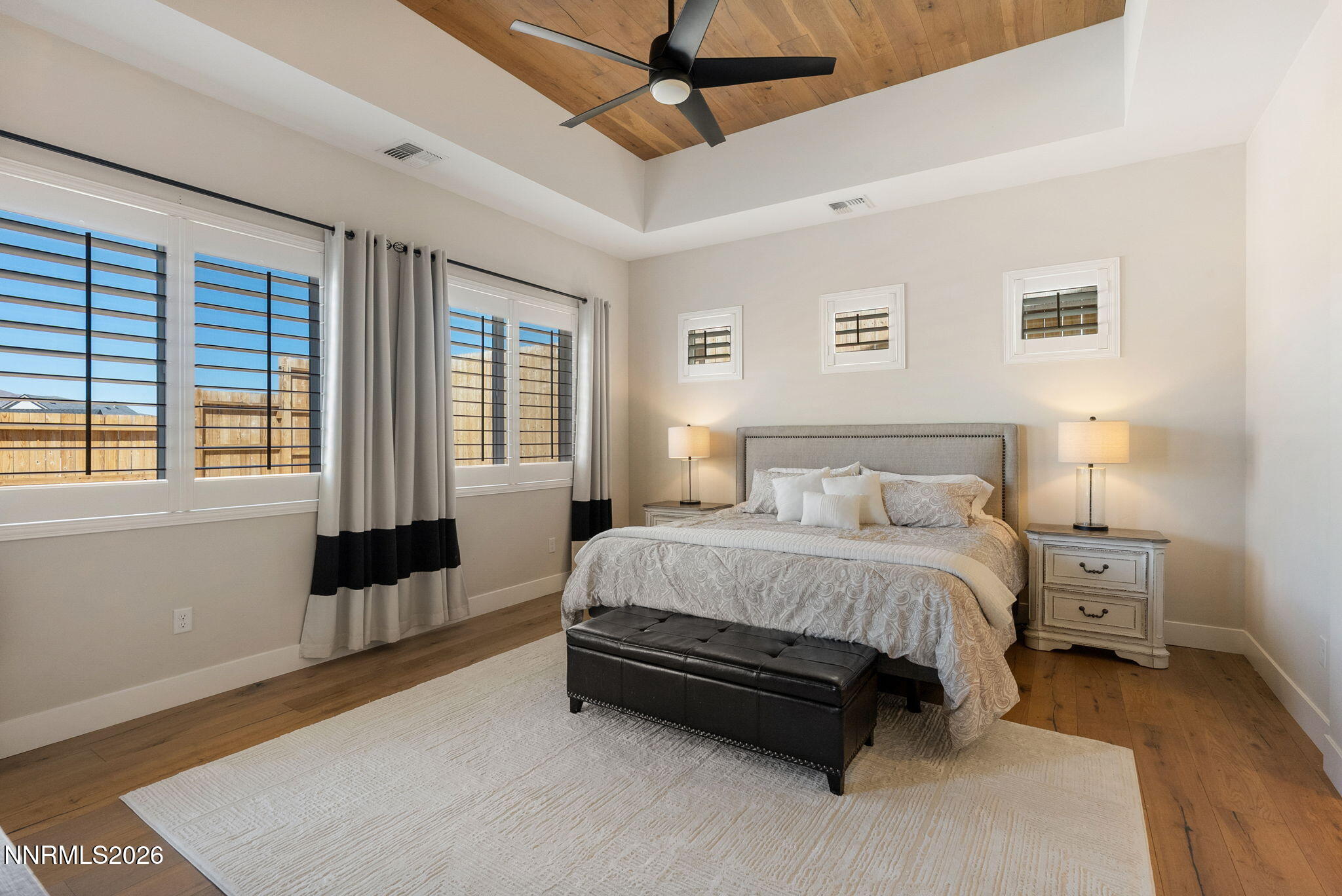 2955 Saddle Peak Drive Reno, NV 89521 - Photo 15 of 38 a spacious bedroom with a bed a couch and a window