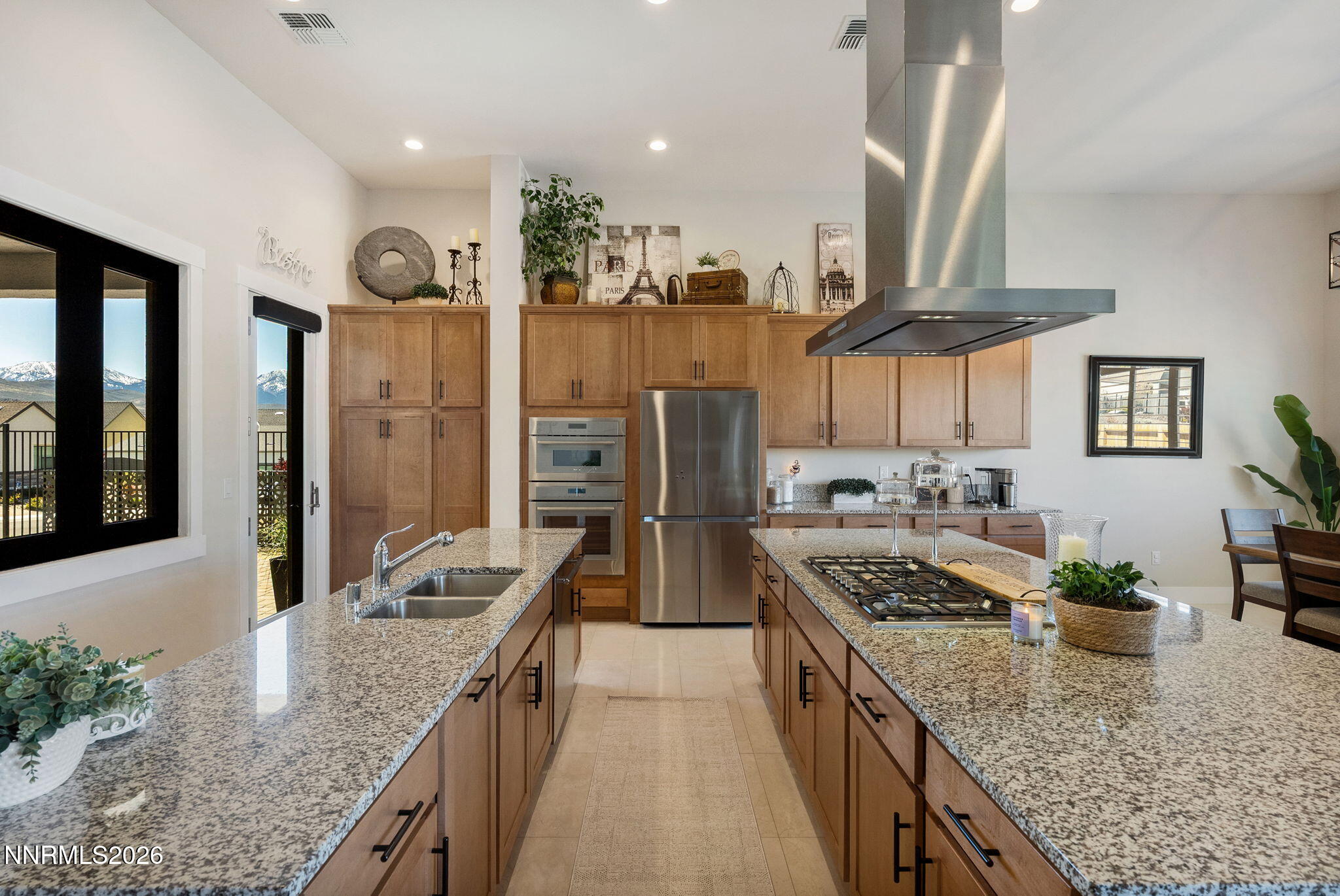 2955 Saddle Peak Drive Reno, NV 89521 - Photo 10 of 38 a kitchen with stainless steel appliances granite countertop a sink a stove and a wooden floors