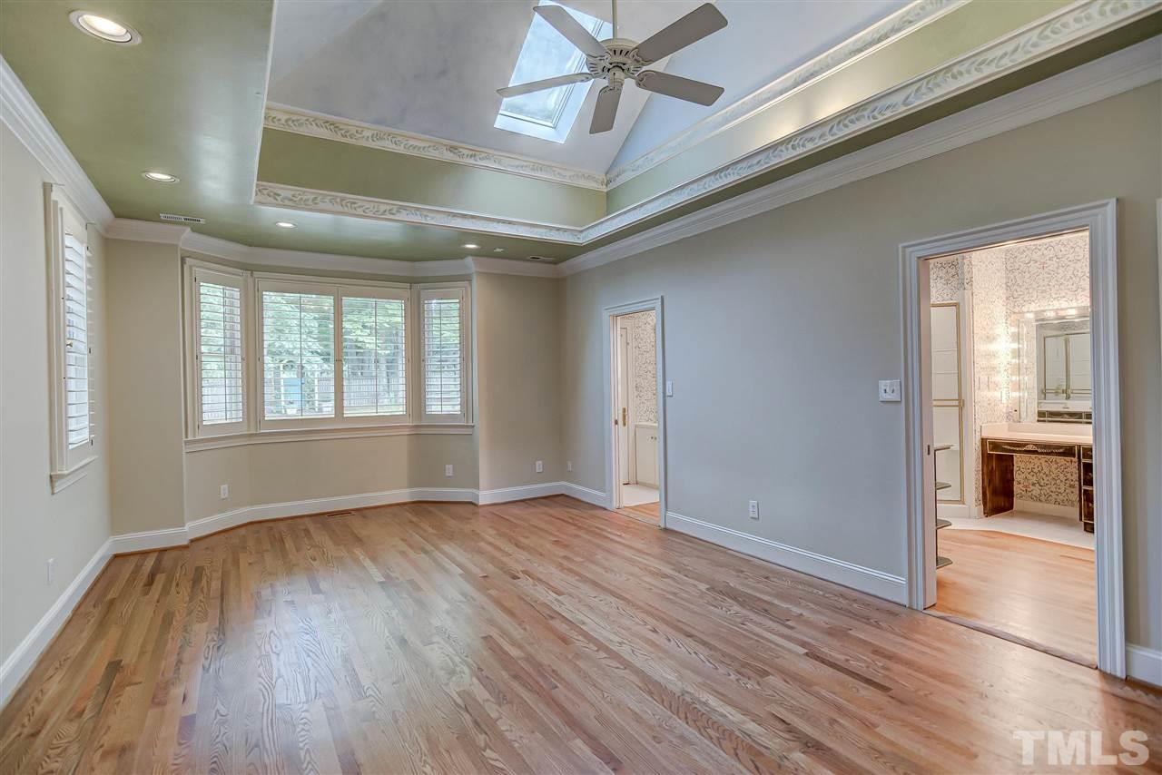 8112 Harps Mill Road Raleigh, NC 27615 - Photo 14 of 30 a view of an empty room with wooden floor and a window