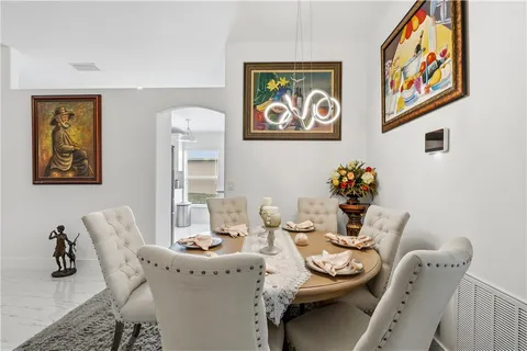 a dining room with furniture and wooden floor