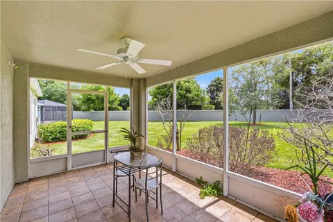 a view of a porch with furniture and a yard