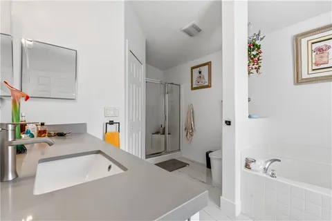 a bathroom with a tub sink and mirror