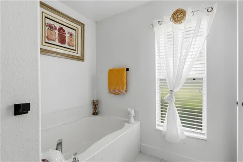 a bathroom with a window and a shower