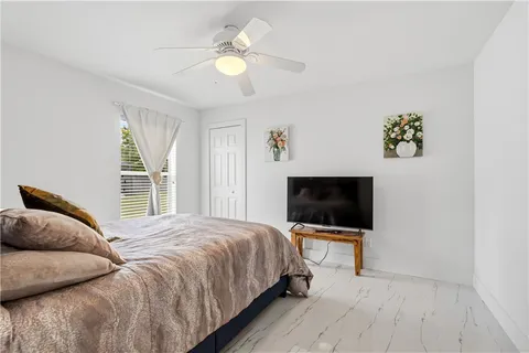 a bedroom with a bed and a flat screen tv
