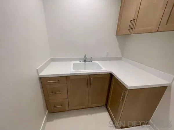 a utility room with wooden cabinets washer and dryer