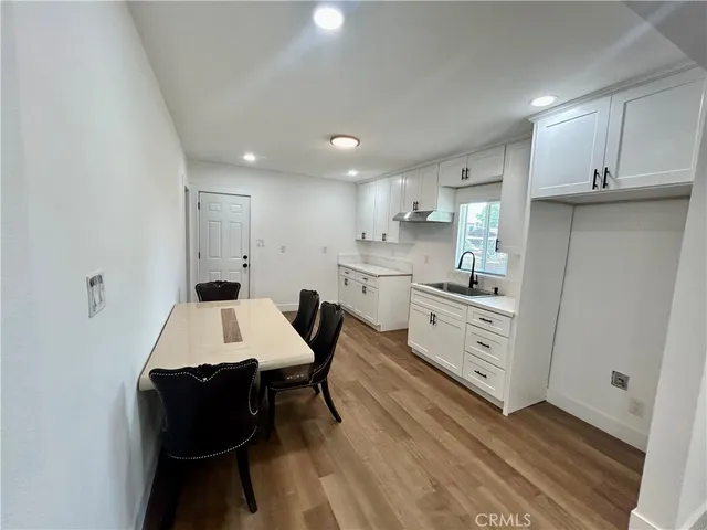 a large white kitchen with cabinets
