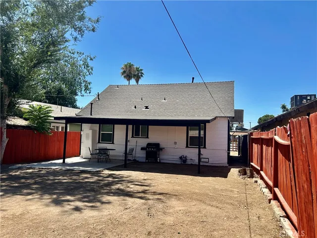 an entrance to house with wooden fence