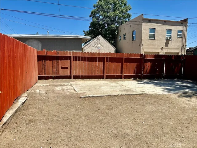 a view of a house with wooden fence