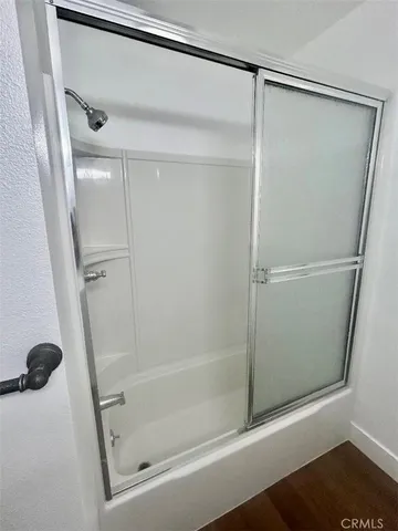 a bathroom with a glass shower door