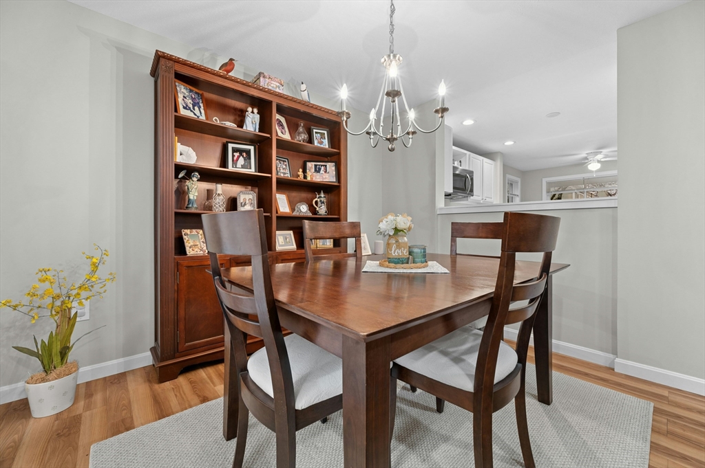 151 Stone Ridge Road, Unit 151 Franklin, MA 02038 - Photo 11 of 39 a view of a dining room with furniture and wooden floor