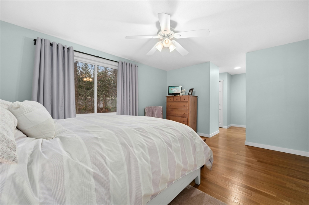151 Stone Ridge Road, Unit 151 Franklin, MA 02038 - Photo 21 of 39 a bedroom with a large bed and a chandelier