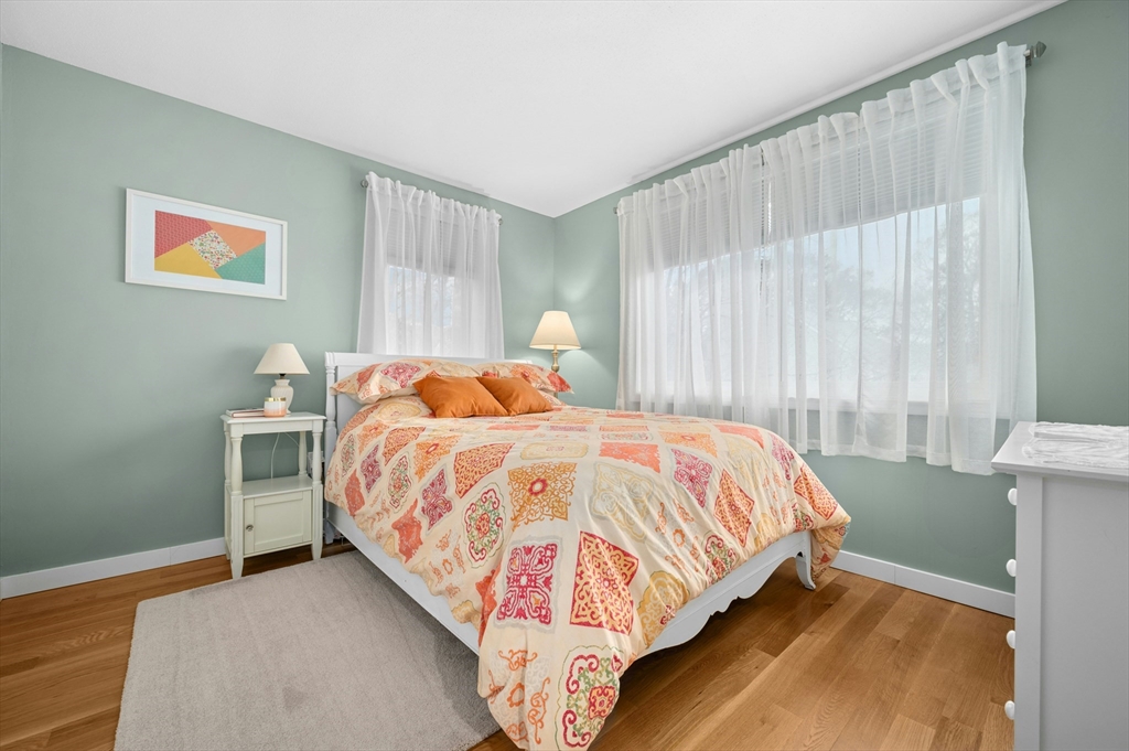 151 Stone Ridge Road, Unit 151 Franklin, MA 02038 - Photo 24 of 39 a bed sitting in a bedroom next to a window