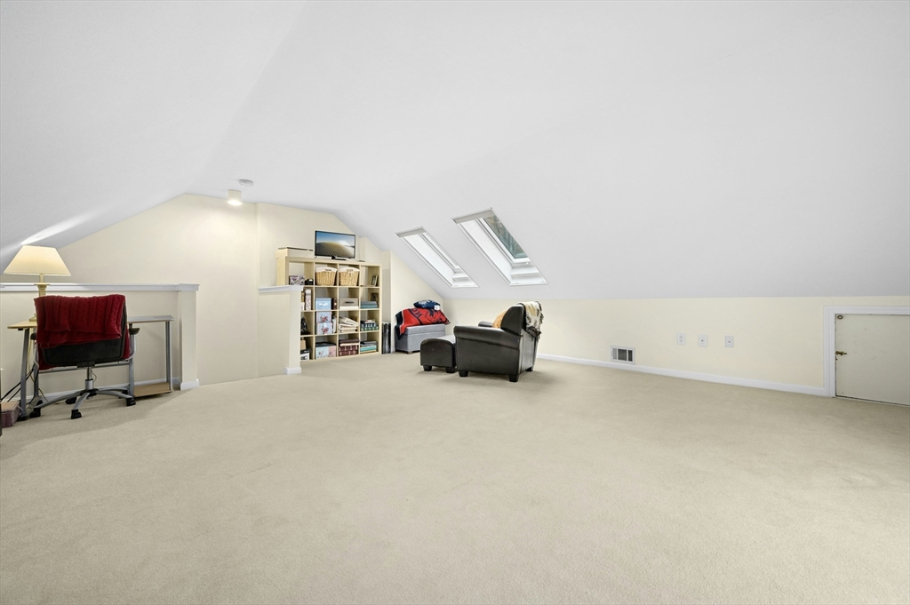 151 Stone Ridge Road, Unit 151 Franklin, MA 02038 - Photo 28 of 39 a view of a livingroom with furniture and a chandelier