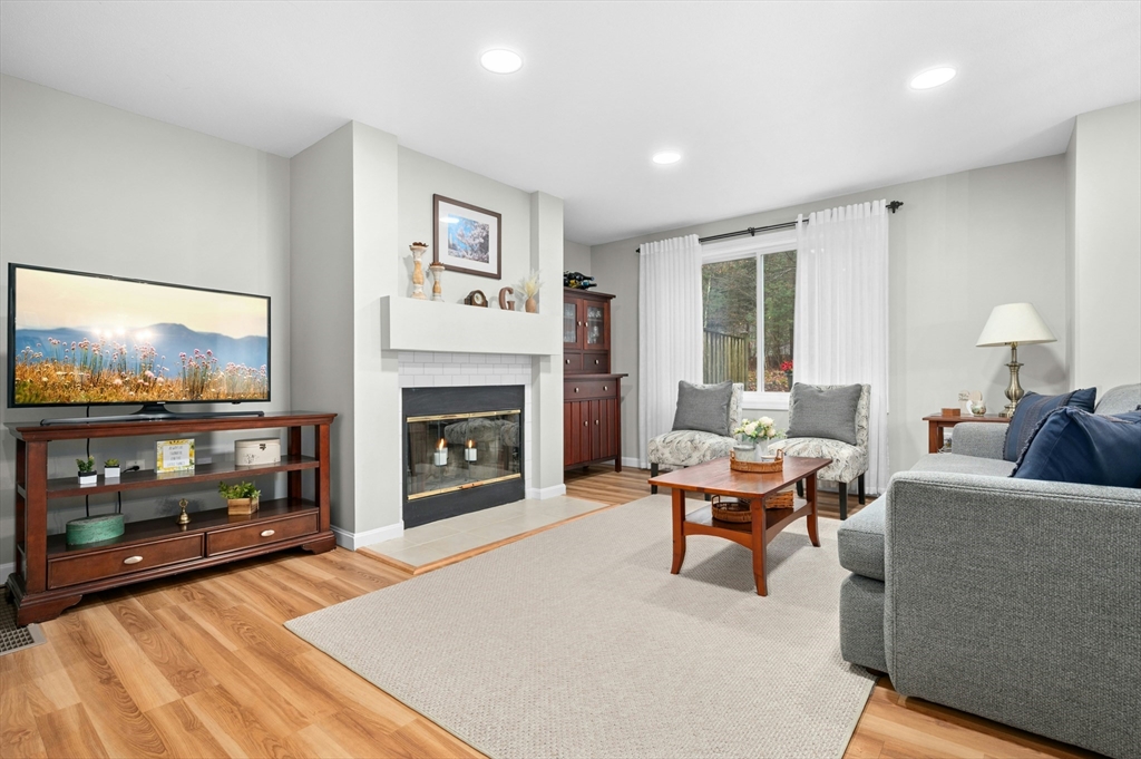 151 Stone Ridge Road, Unit 151 Franklin, MA 02038 - Photo 7 of 39 a living room with furniture a flat screen tv and a fireplace