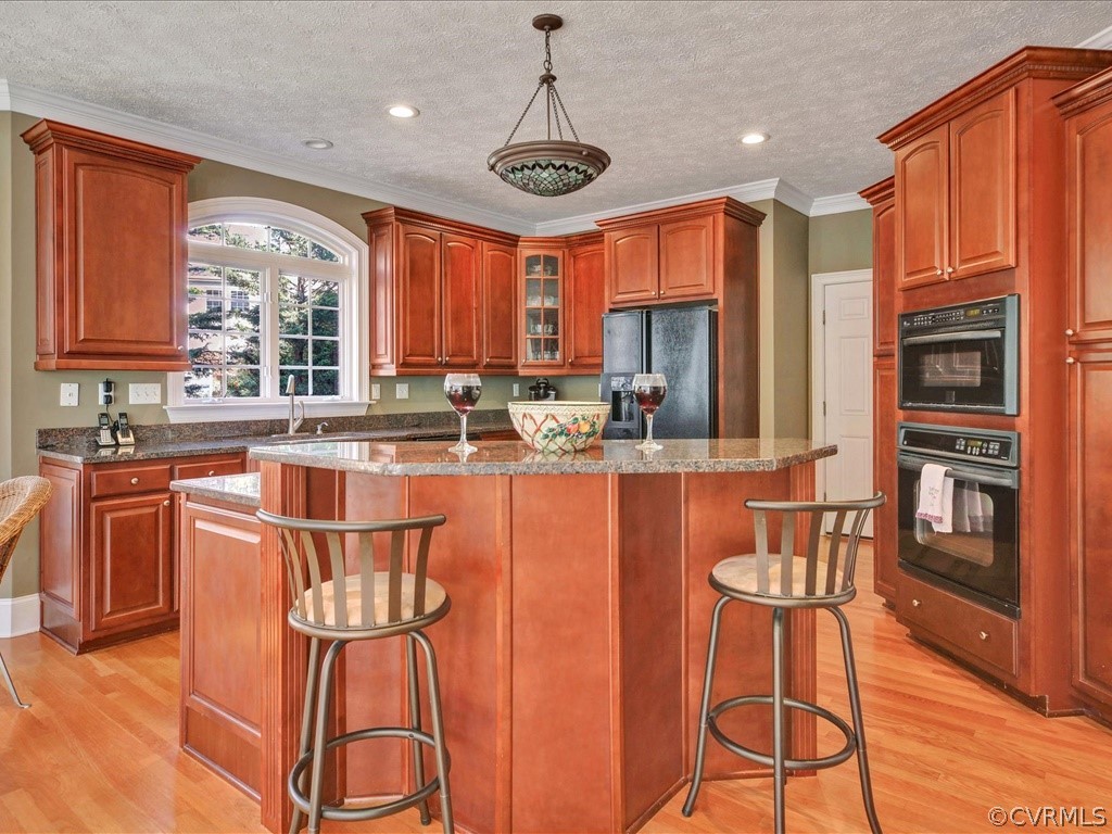 13711 Beechwood Point Road Midlothian, VA 23112 - Photo 12 of 49 a kitchen with stainless steel appliances granite countertop a stove a sink dishwasher a dining table and chairs with wooden floor