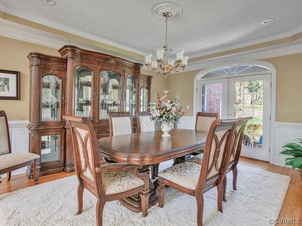 13711 Beechwood Point Road Midlothian, VA 23112 - Photo 7 of 49 a dining room with furniture a chandelier and wooden floor