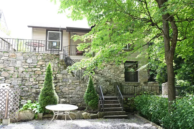 a view of a chairs and table in backyard of the house