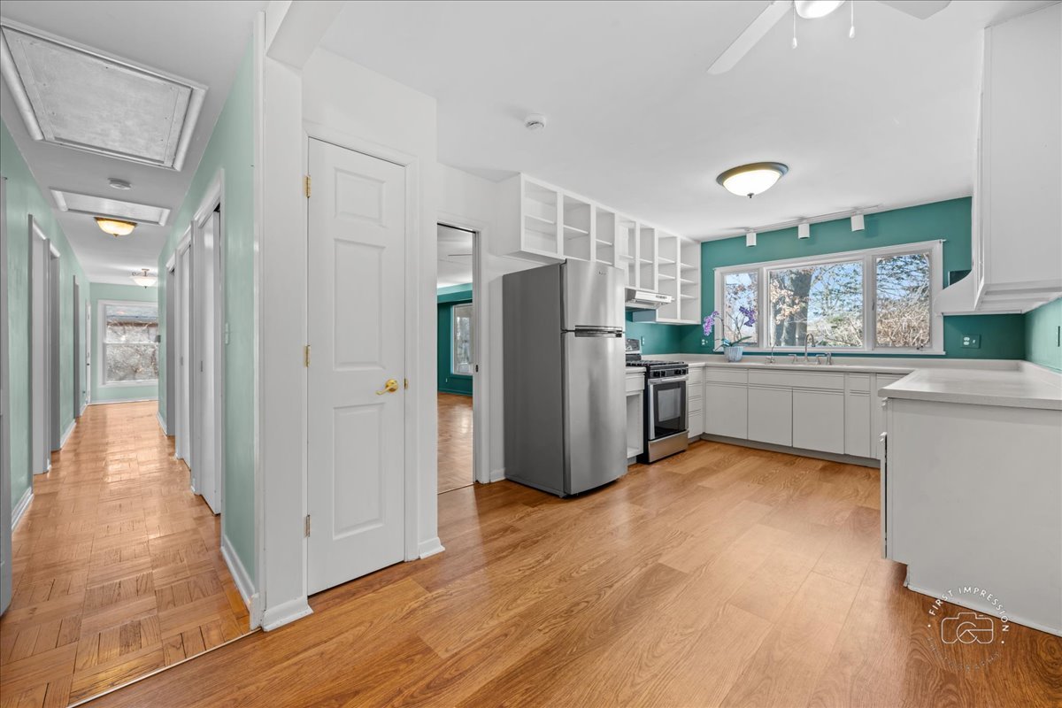 337 Republic Road Batavia, IL 60510 - Photo 5 of 22 a view of a kitchen with a refrigerator a microwave and a sink