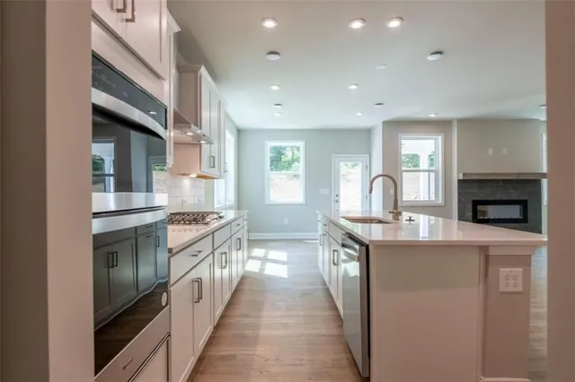 a kitchen with stainless steel appliances granite countertop a stove and a sink