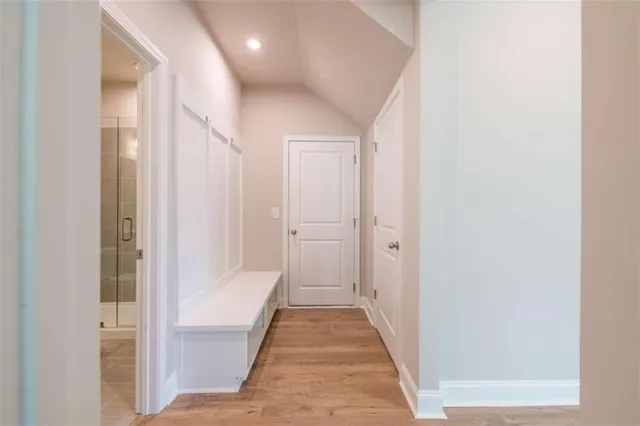 a view of a hallway with white doors