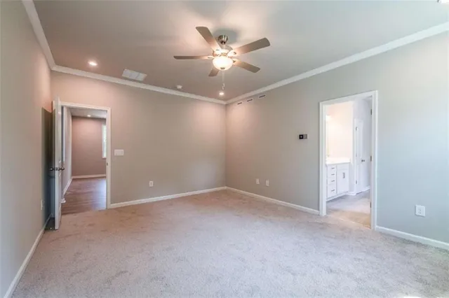 a view of an empty room with a ceiling fan
