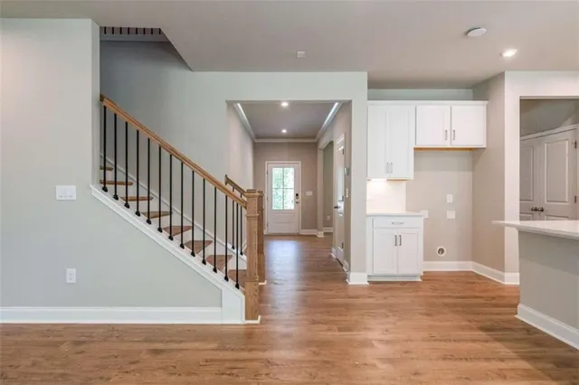 a view of entryway and hall with wooden floor