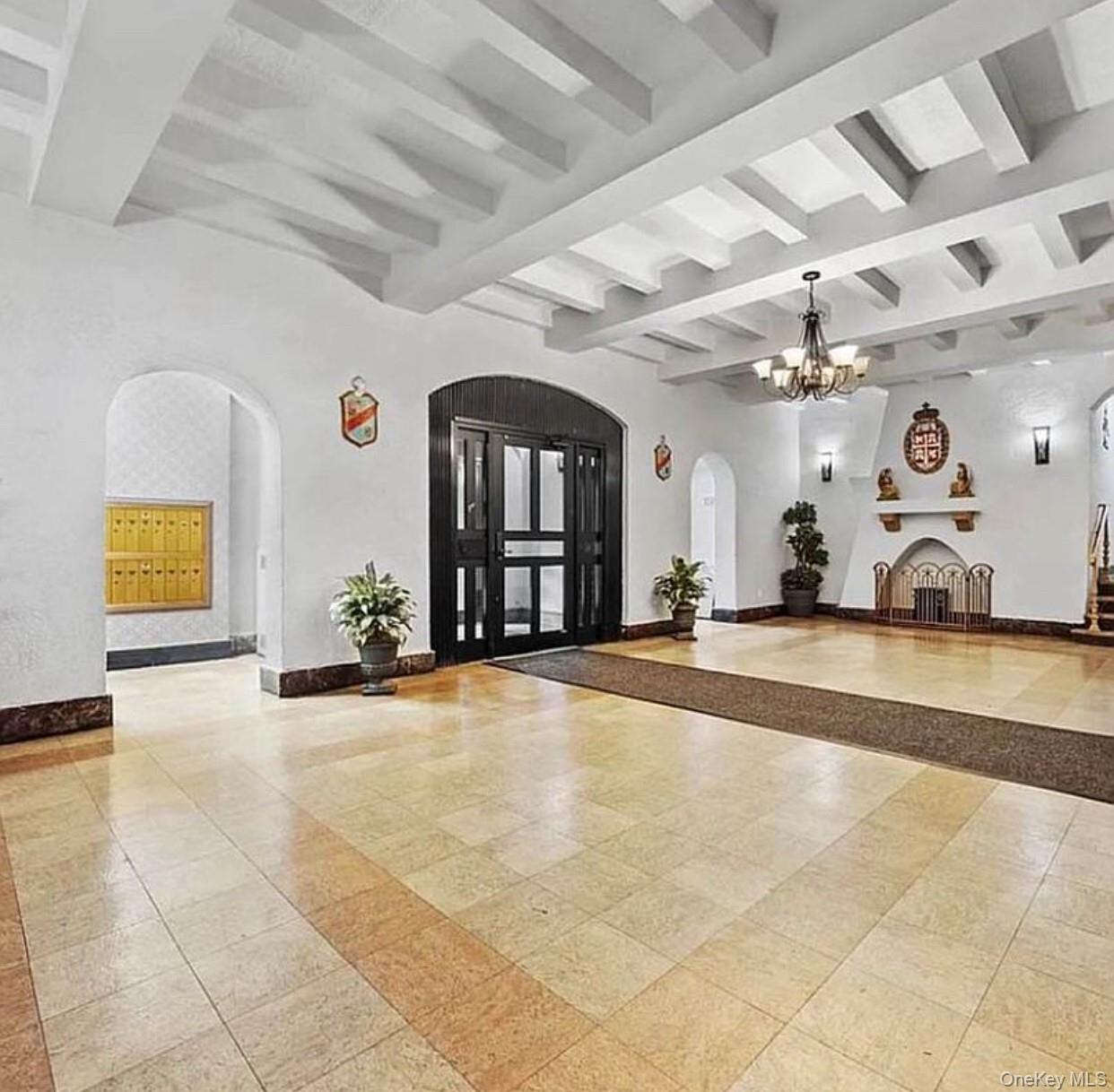 37-21 80th Street, Unit 1F Queens, NY 11372 - Photo 2 of 4 a view of a livingroom with a fireplace and furniture