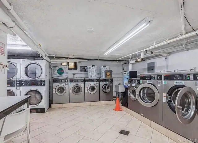 a utility room with dryer and cabinets