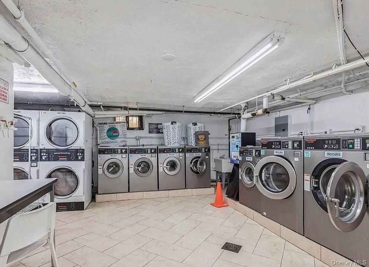 37-21 80th Street, Unit 1F Queens, NY 11372 - Photo 4 of 4 a utility room with dryer and cabinets